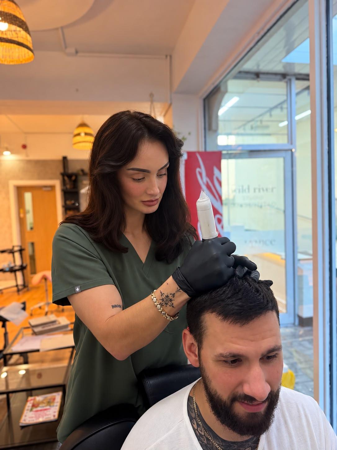Amy carrying out scalp micropigmentation on a client at her Blackpool studio