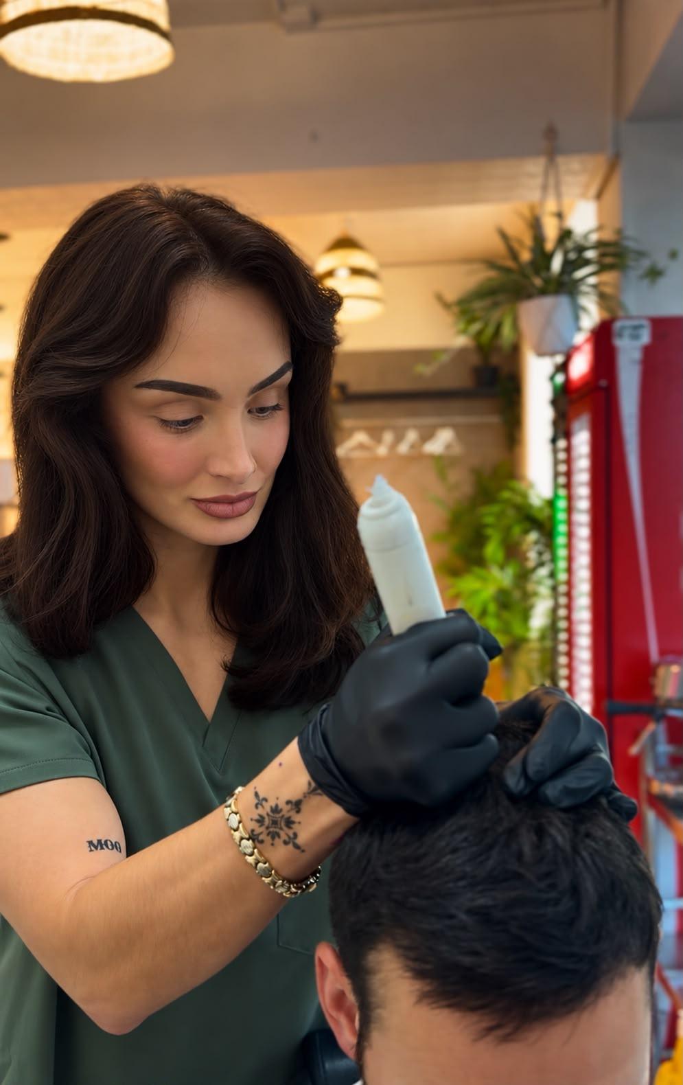 Amy concentrating on a scalp micropigmentation treatment