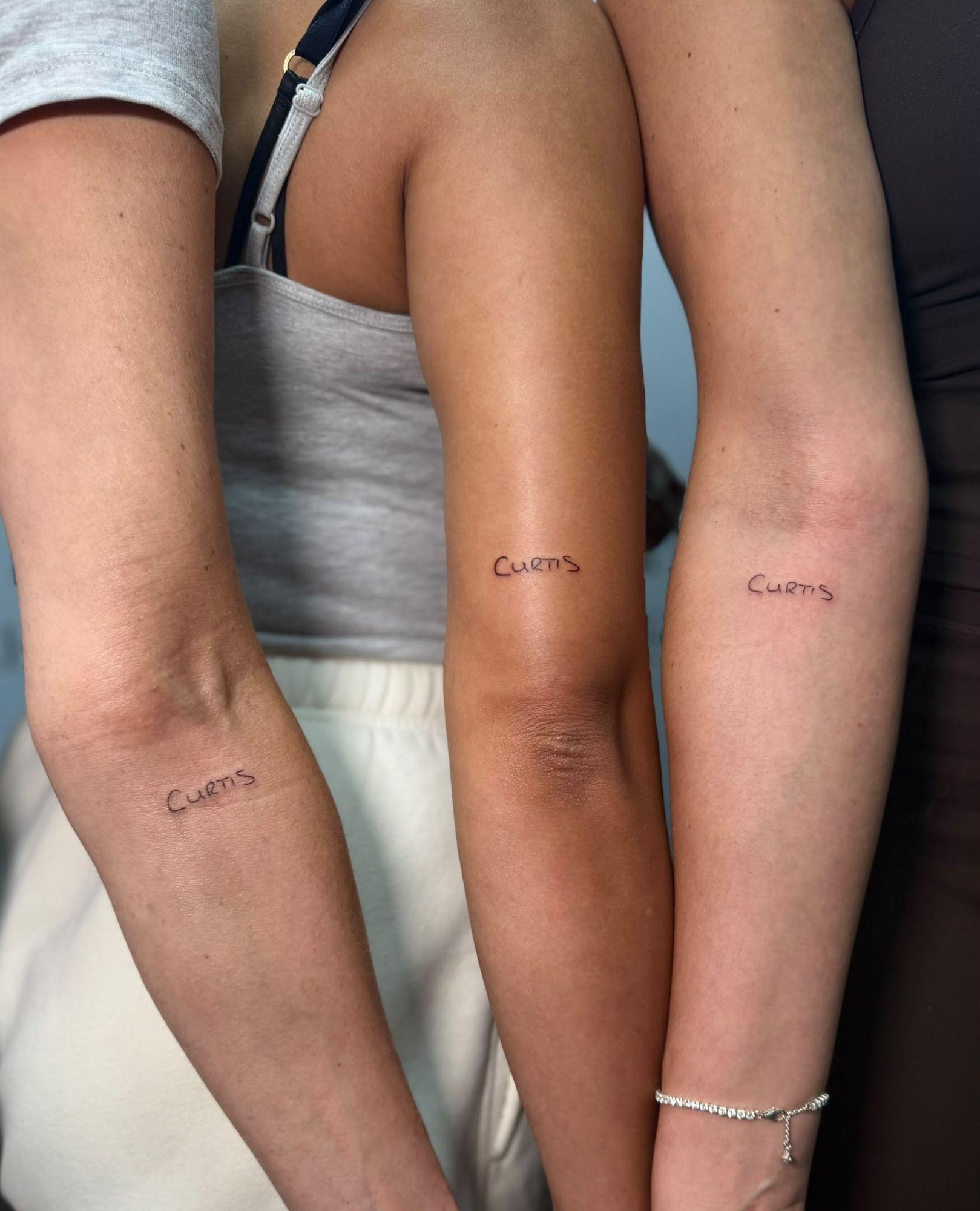 Matching handwritten name tattoos on three forearms